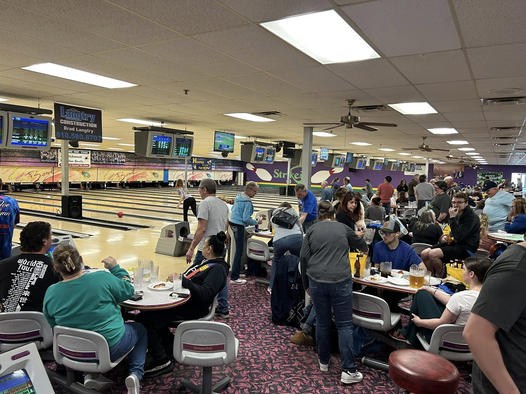 Guests bowling during a busy event night at Strikers